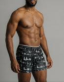Male model wearing Savage Tacticians black graphic boxer briefs with bold waistband logo