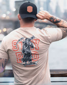 Savage Tacticians t-shirt with grim reaper graphic and STAY RAD text, worn by tattooed man