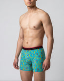 Man wearing Savage Tacticians aqua boxer briefs with colorful tropical print