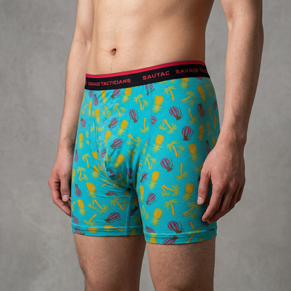 Man wearing Savage Tacticians boxer briefs with pineapple and palm tree print