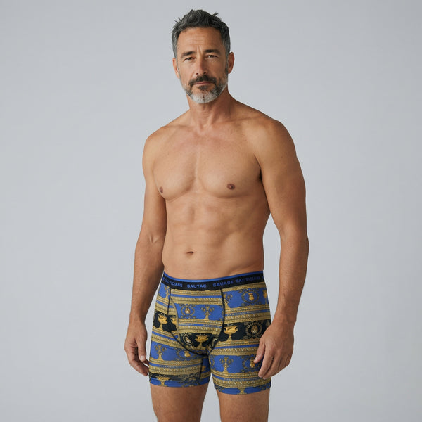 Man modeling Savage Tacticians blue and gold patterned boxer briefs, front view